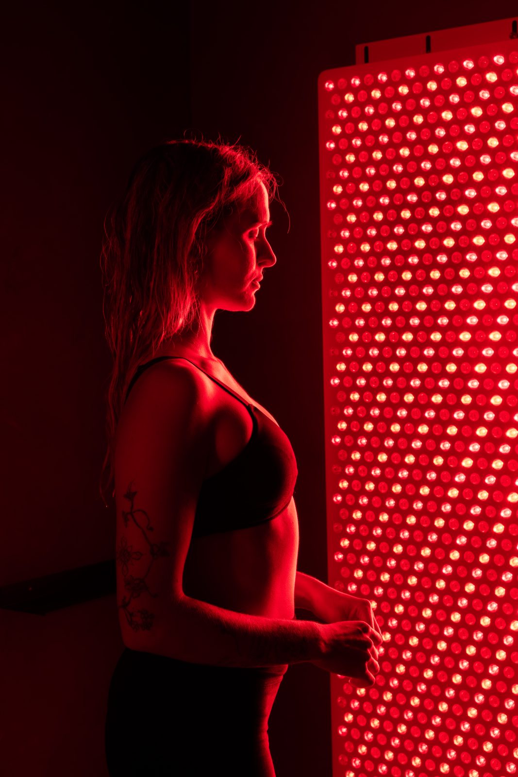 Guest facing the full-body red light panel
